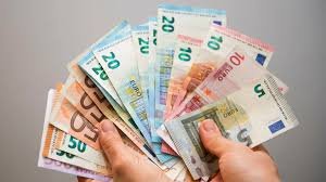 Imagen de unas manos con un abanico de billetes